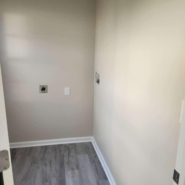 washroom featuring dark hardwood / wood-style flooring and hookup for an electric dryer