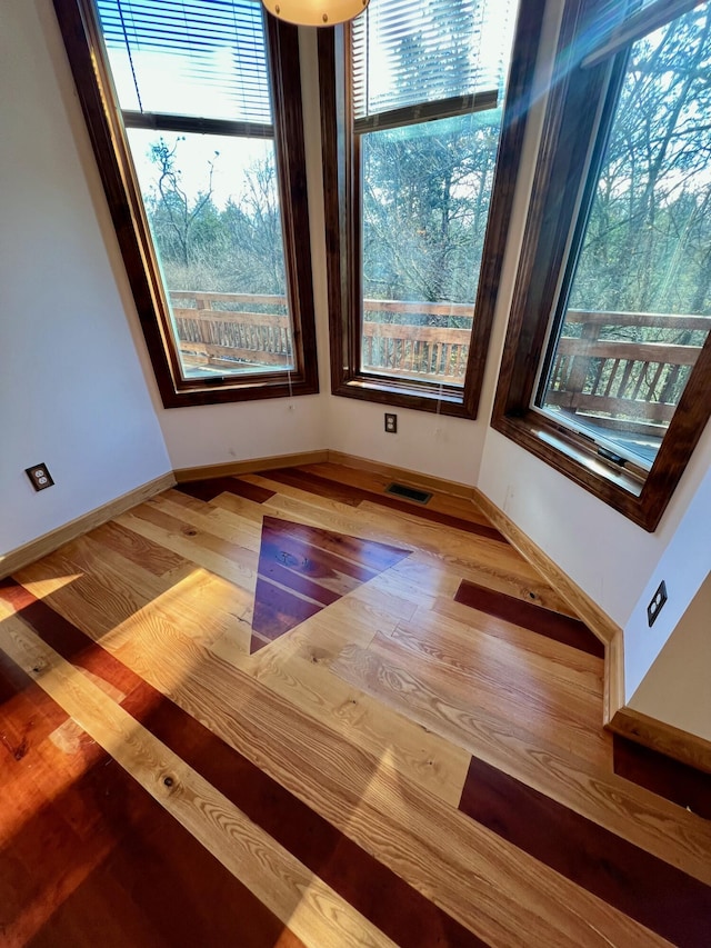 unfurnished room featuring hardwood / wood-style flooring