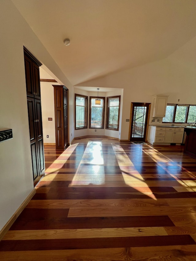 spare room featuring dark wood-type flooring and a healthy amount of sunlight