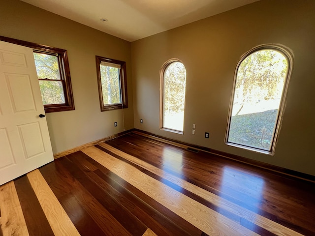 unfurnished room featuring hardwood / wood-style flooring