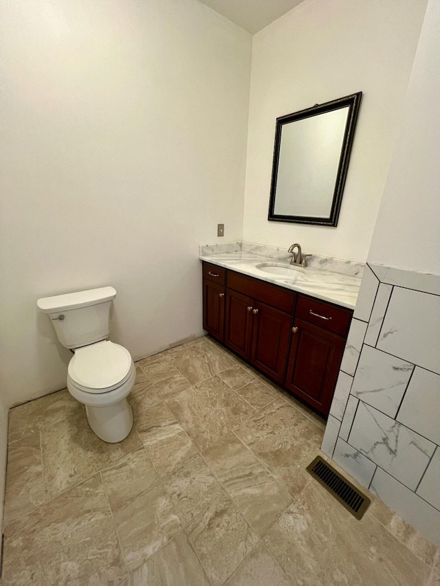 bathroom featuring toilet and vanity