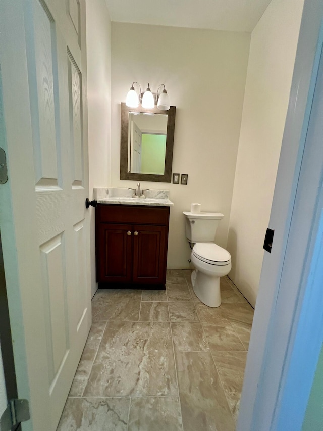 bathroom with toilet and vanity