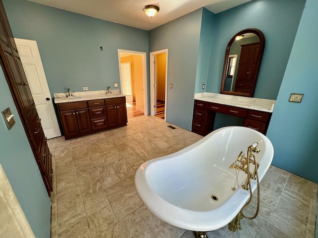 bathroom with vanity and a bath