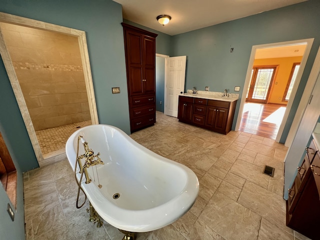 bathroom featuring separate shower and tub and vanity