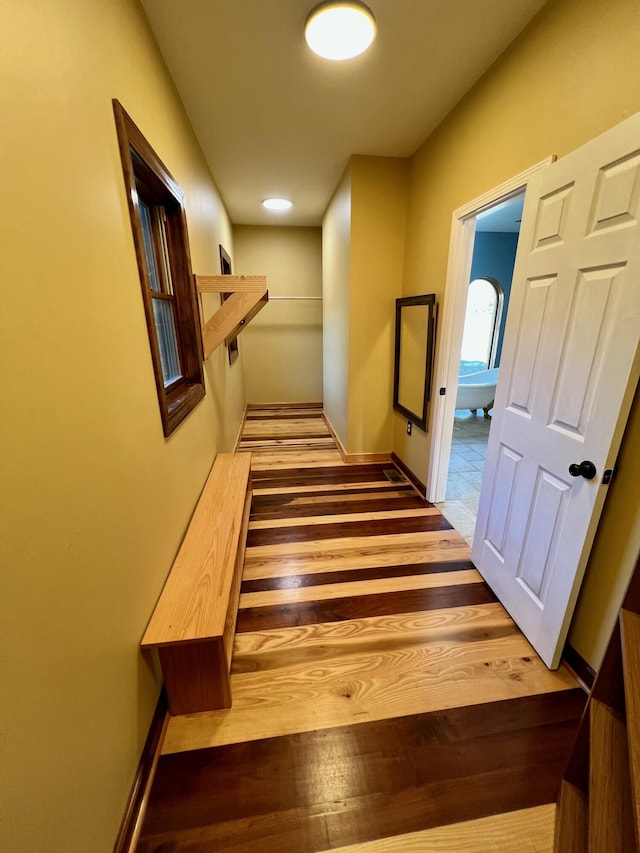 stairway featuring wood-type flooring