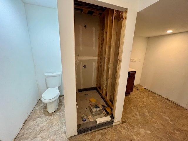 bathroom featuring toilet and vanity