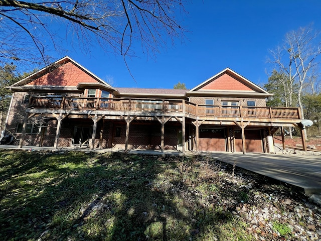 exterior space with a garage, a deck, and a front lawn