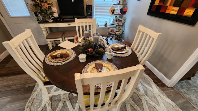 dining area with dark hardwood / wood-style floors