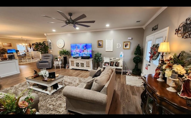 living room featuring ceiling fan with notable chandelier, french doors, hardwood / wood-style floors, and ornamental molding