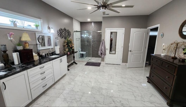 bathroom featuring ceiling fan, walk in shower, and vanity