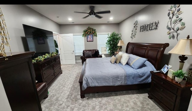 bedroom featuring light carpet and ceiling fan