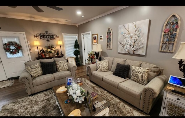 living room featuring hardwood / wood-style flooring, ceiling fan, and crown molding