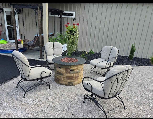 view of patio / terrace featuring an outdoor fire pit