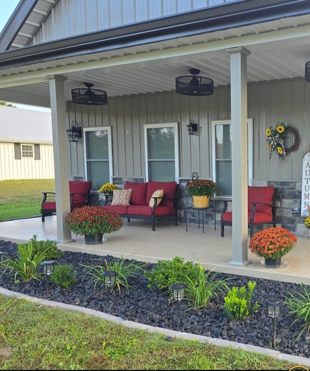 exterior space with a porch and ceiling fan