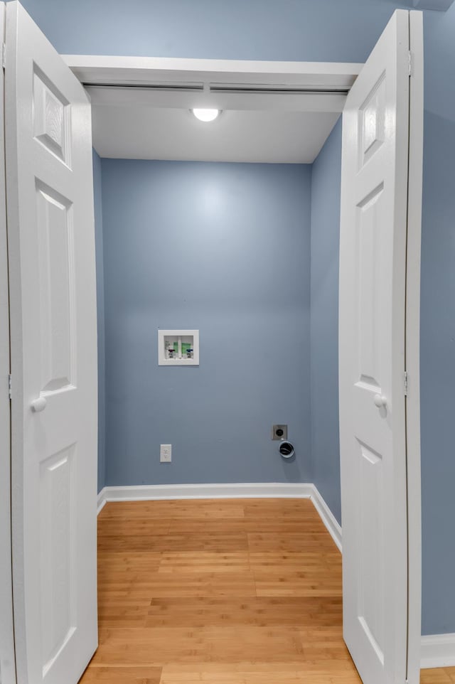 washroom featuring hookup for a washing machine, light hardwood / wood-style flooring, and hookup for an electric dryer