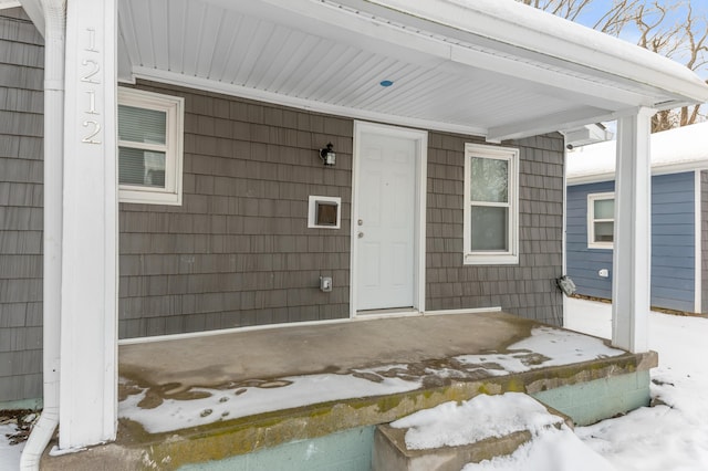 view of snow covered property entrance