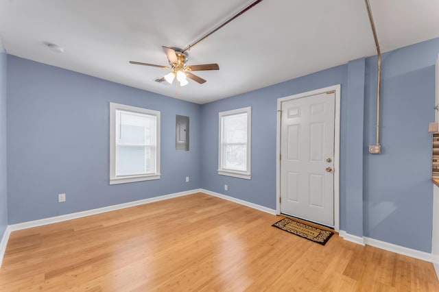 entryway with ceiling fan, light wood-type flooring, and electric panel