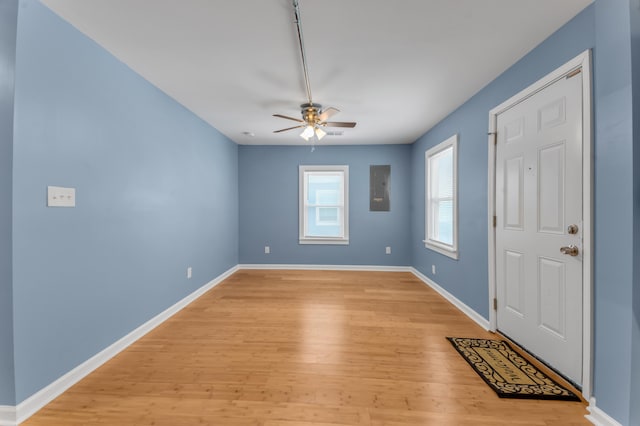 foyer entrance with ceiling fan and light hardwood / wood-style flooring