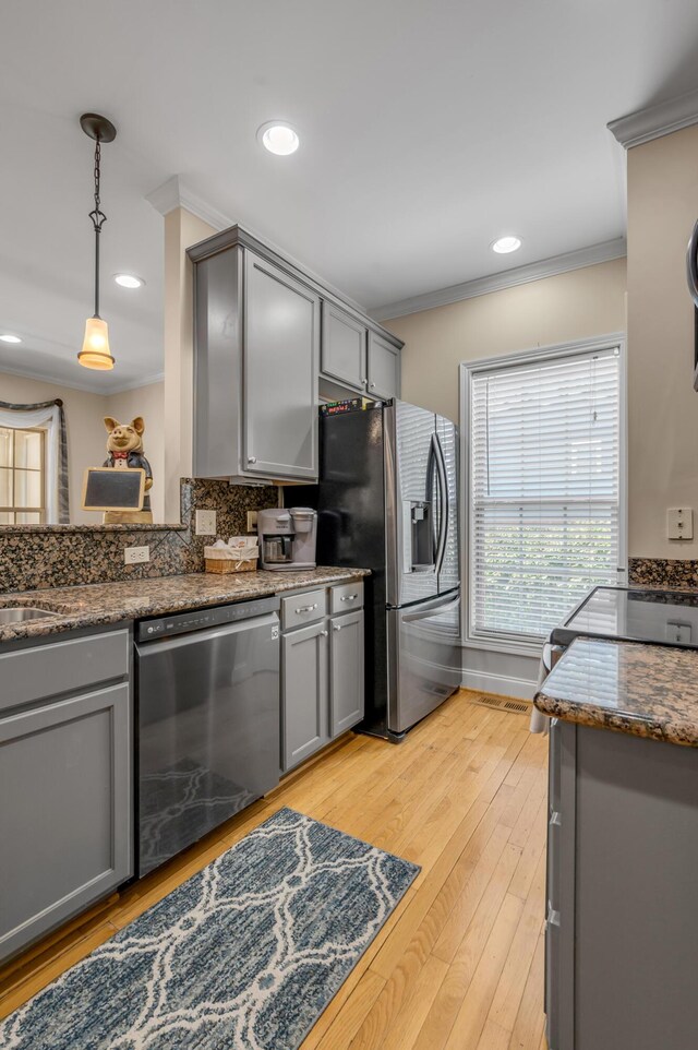 kitchen featuring stainless steel fridge, decorative light fixtures, gray cabinets, and black dishwasher