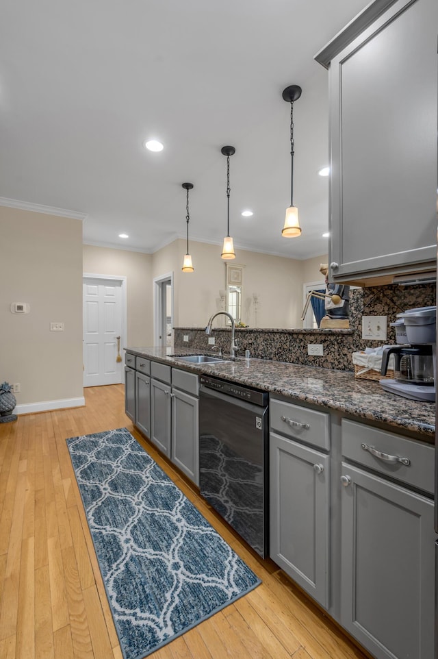 kitchen featuring pendant lighting, dishwasher, gray cabinetry, and sink