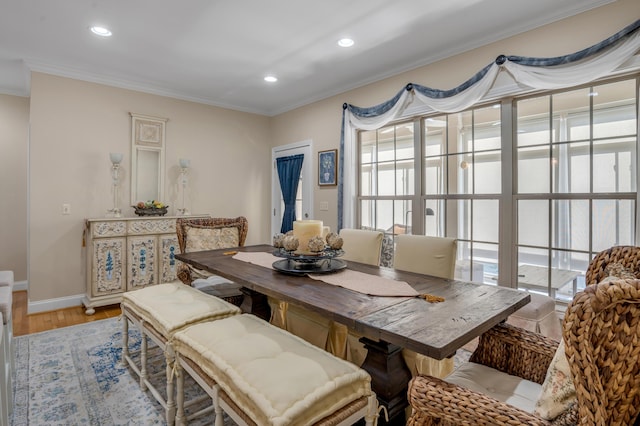 dining room with light hardwood / wood-style floors, plenty of natural light, and ornamental molding