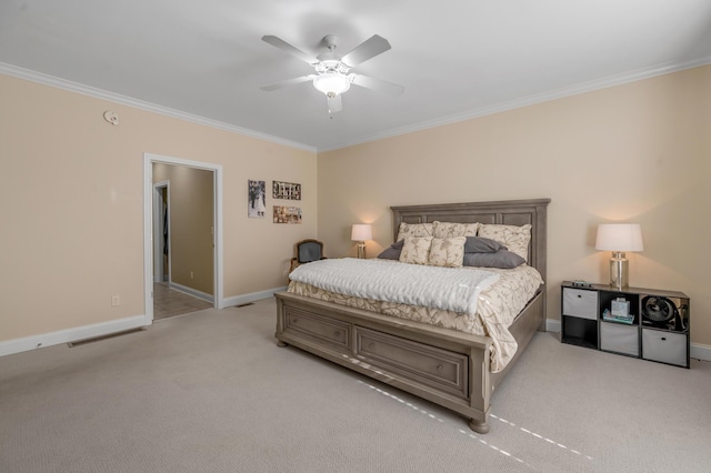 bedroom featuring ceiling fan, crown molding, and light carpet