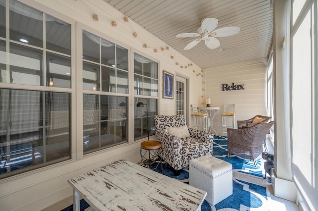 sunroom featuring ceiling fan