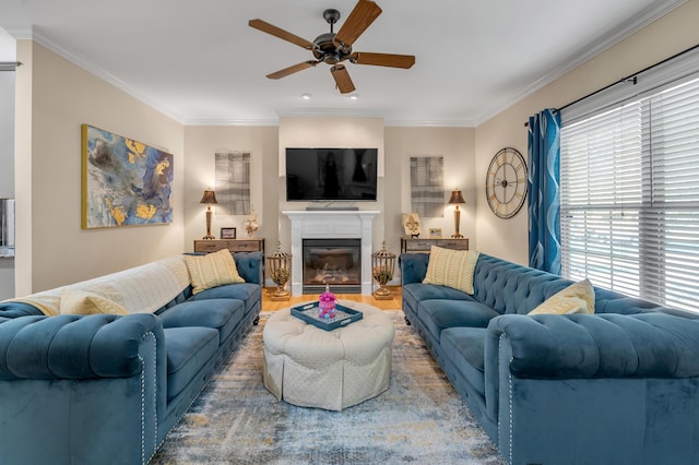 living room featuring plenty of natural light, crown molding, and ceiling fan