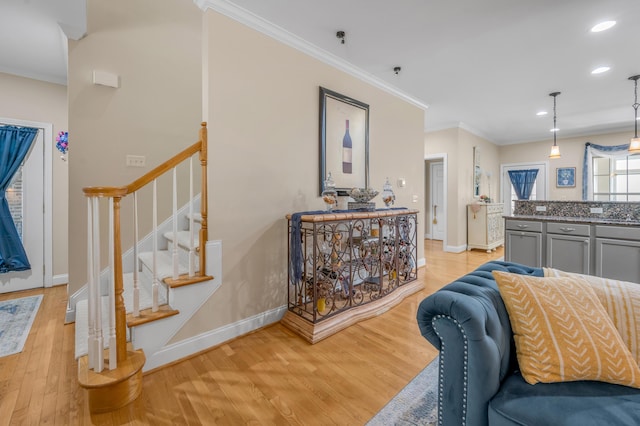 living room featuring light wood-type flooring and ornamental molding