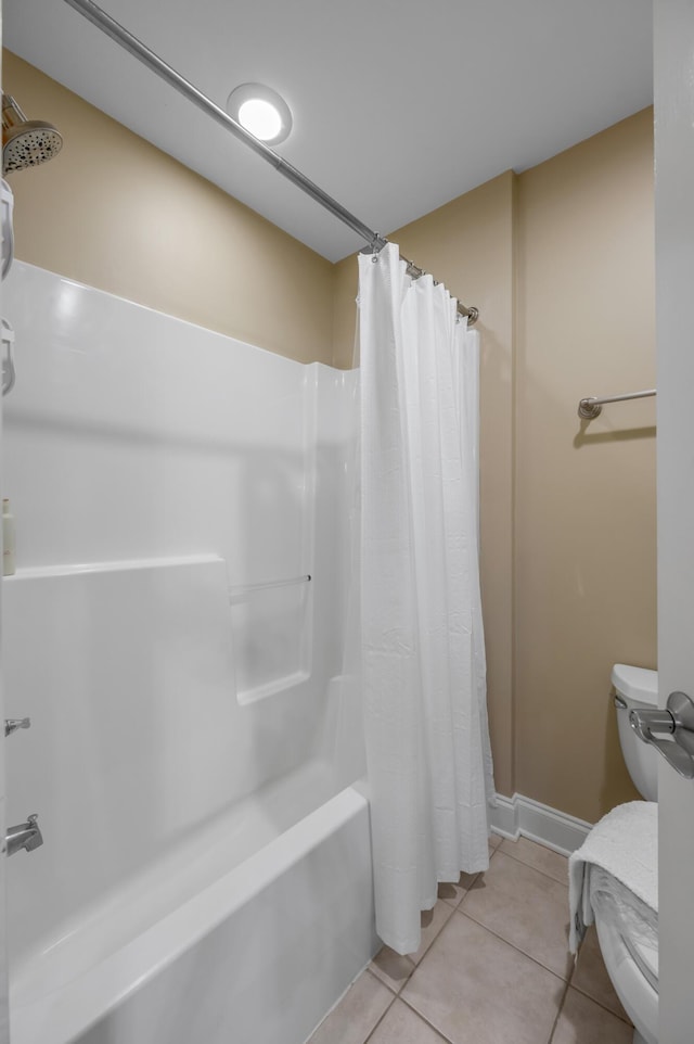 bathroom with tile patterned floors and shower / bath combo