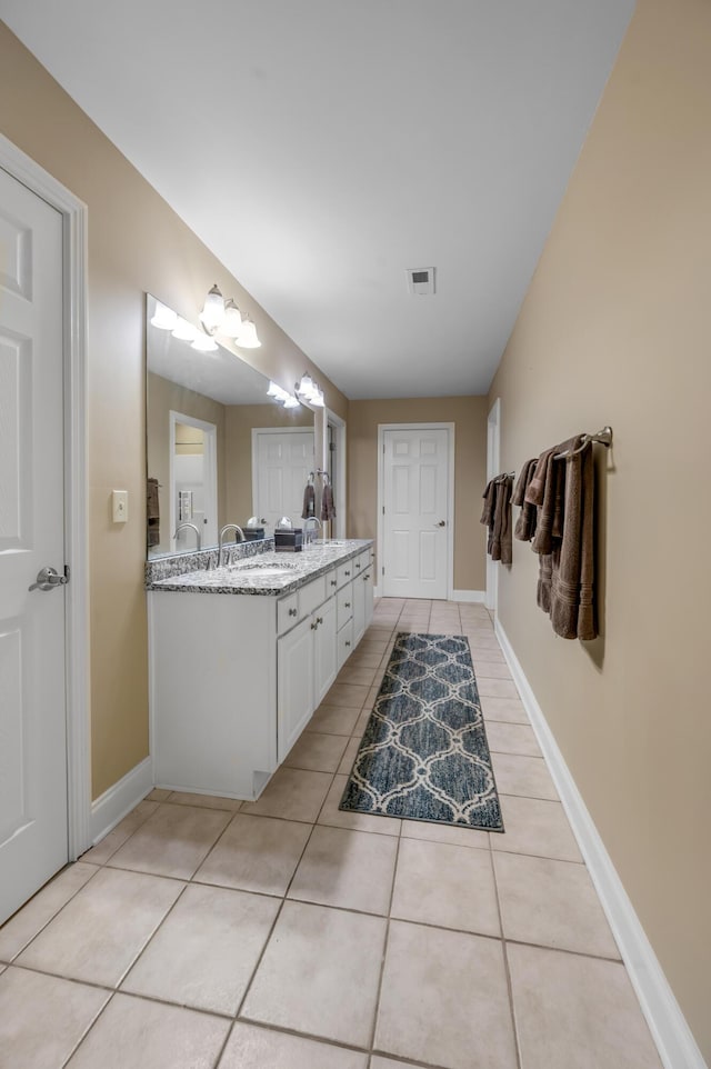 bathroom featuring tile patterned flooring and vanity