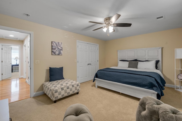 bedroom with light carpet, a closet, and ceiling fan