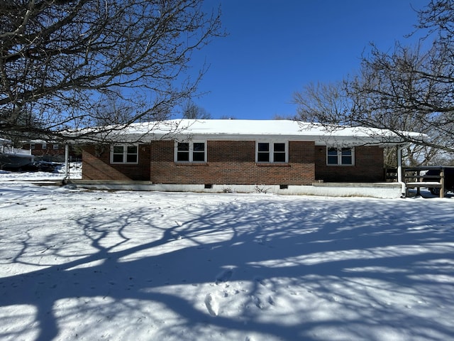 view of snow covered rear of property