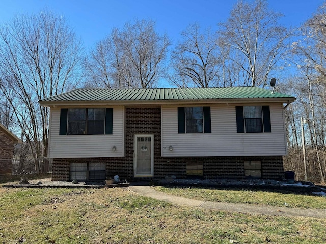 raised ranch featuring a front lawn