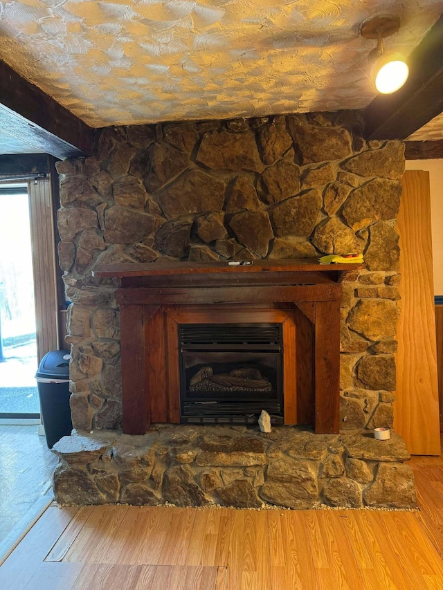 room details featuring a fireplace and wood-type flooring