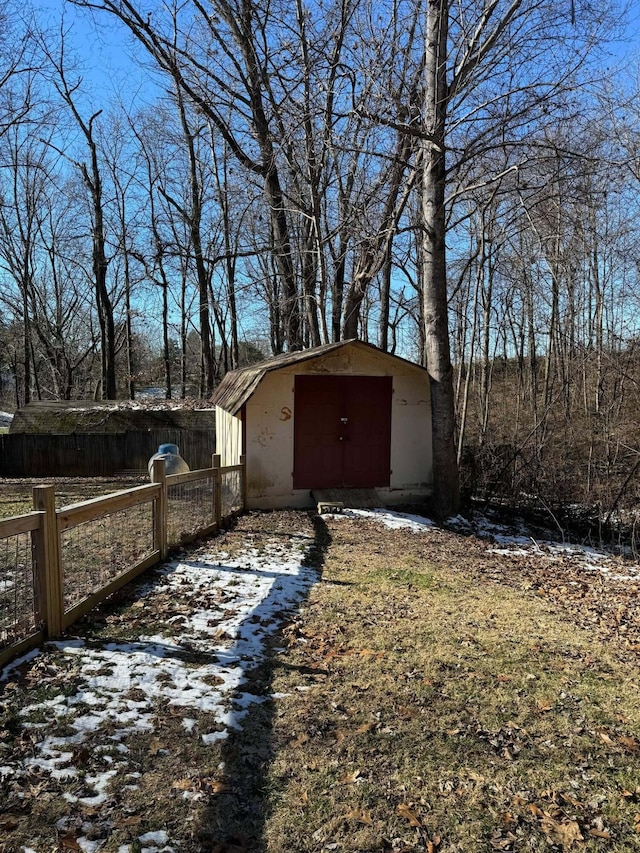 yard covered in snow featuring a storage unit