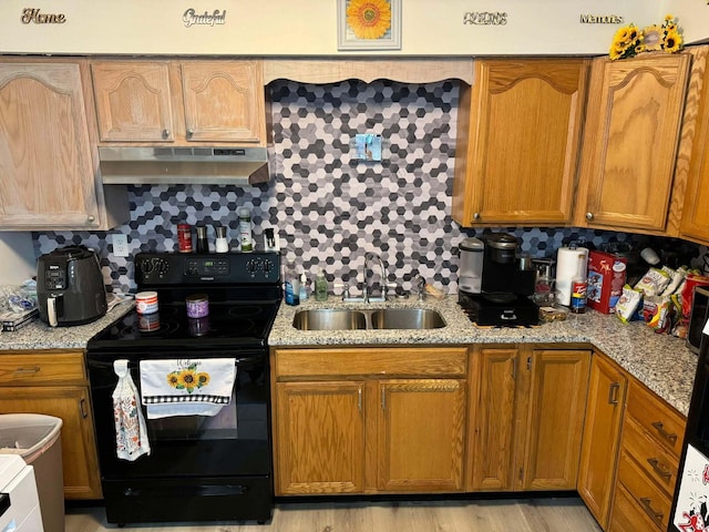 kitchen with backsplash, sink, black range with electric cooktop, and light hardwood / wood-style flooring