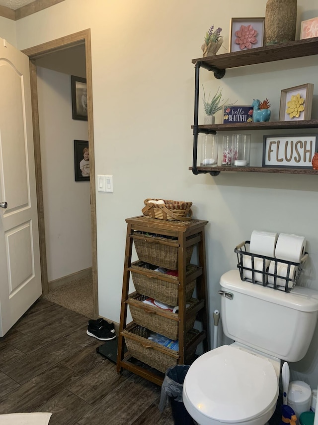 bathroom featuring toilet and wood-type flooring