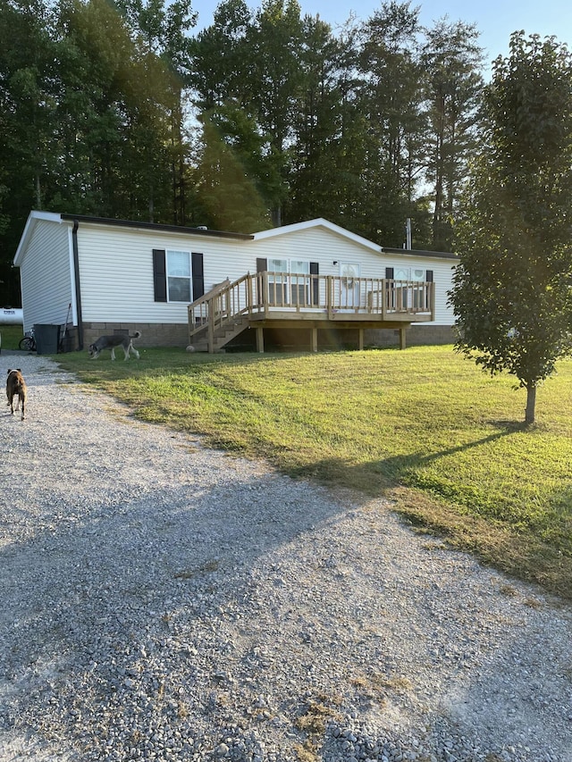 view of front of house with a front lawn and a wooden deck