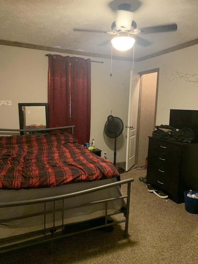 bedroom featuring carpet flooring, a textured ceiling, and ceiling fan