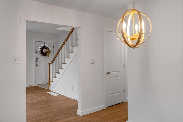 interior space featuring wood-type flooring and a chandelier