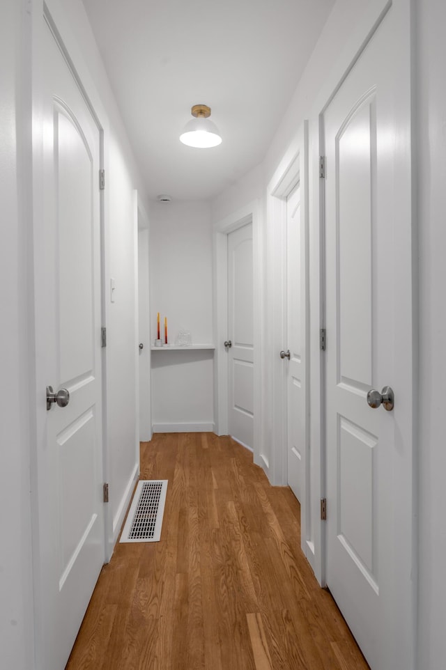 hallway with light wood-type flooring