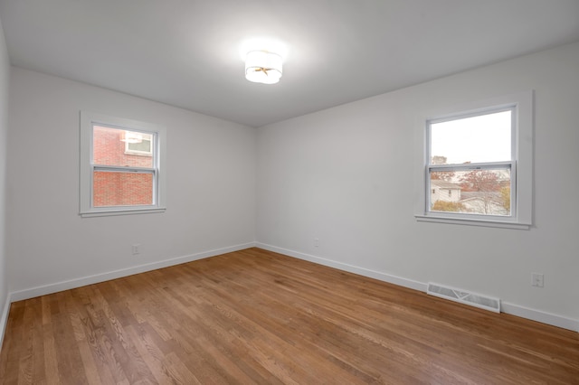 empty room with hardwood / wood-style flooring