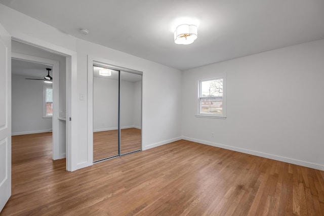 unfurnished bedroom with hardwood / wood-style floors and a closet