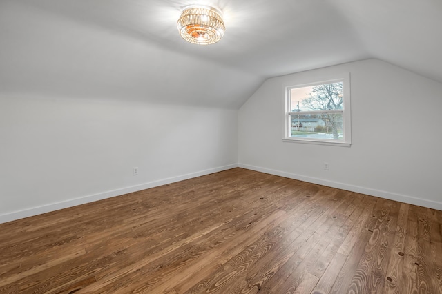 additional living space featuring hardwood / wood-style flooring and lofted ceiling