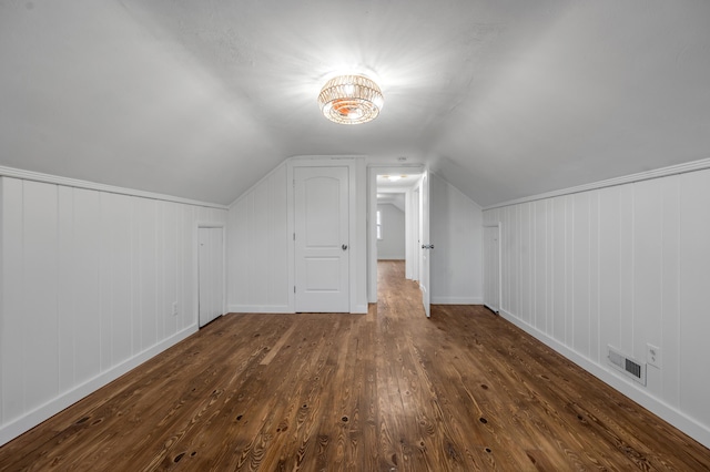 additional living space featuring dark hardwood / wood-style floors and vaulted ceiling