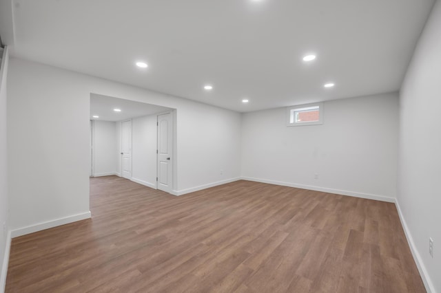 basement with light hardwood / wood-style flooring