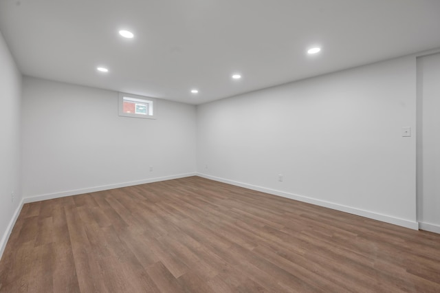 basement with hardwood / wood-style floors