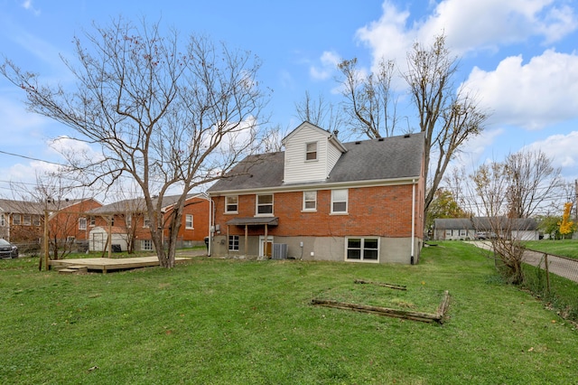 rear view of house featuring a wooden deck, a yard, and cooling unit