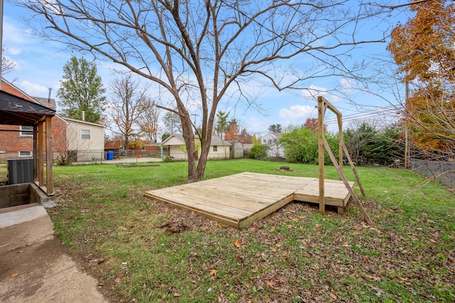 view of yard with a wooden deck and central air condition unit